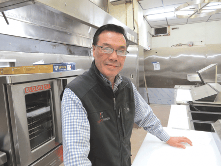 Andy Yee stands in the new kitchen at the Fort