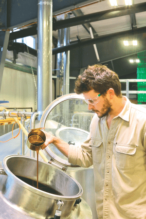 Nate Lanier crafts a brew at Tree House’s headquarters in Monson.