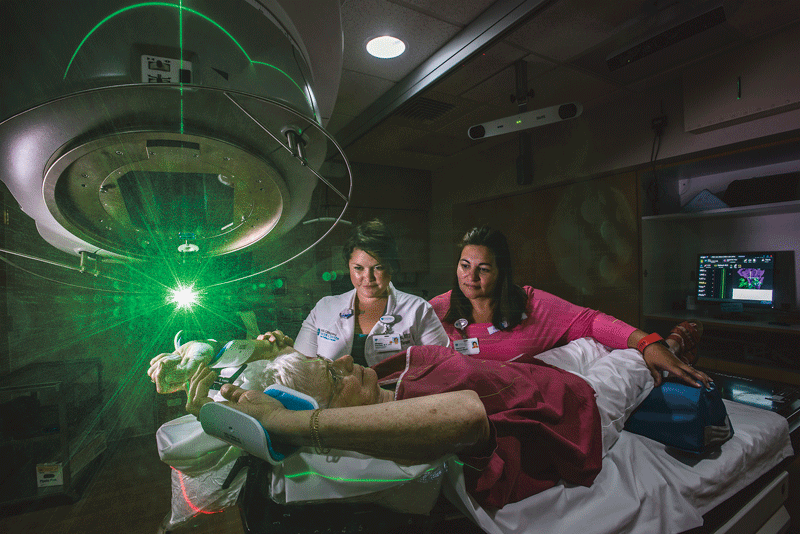 Radiation therapists treat a patient in the Mass General Cancer Center at Cooley Dockinson Hospital. 