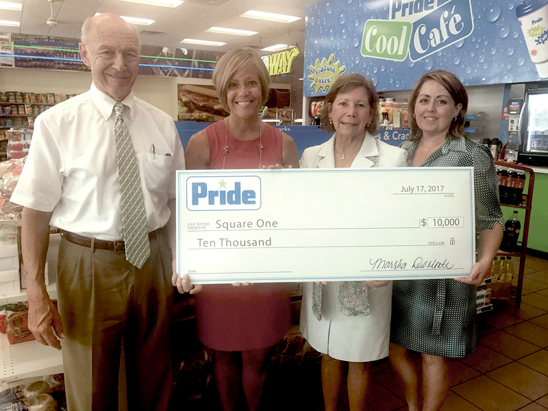 Bob Bolduc and Pride Stores President Marsha Del Monte (right) present a $10,000 check