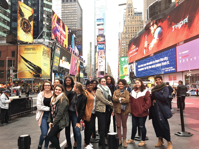 Cynthia Carson, far right, leads her guests on a tour of Times Square