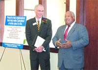 Doug Bowen, left, president and CEO of PeoplesBank, congratulates Henry Thomas III,