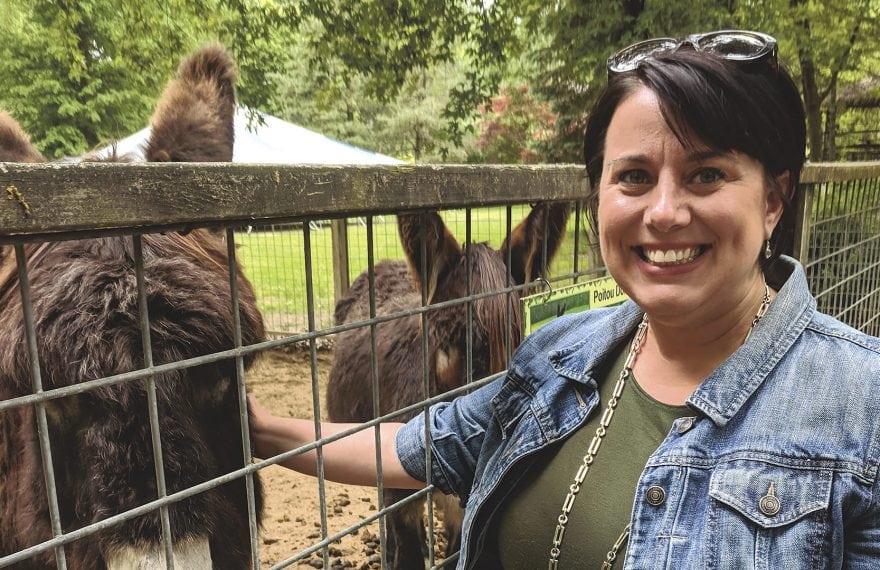 Executive Director Sarah Tsitso with a couple of poitou donkeys.