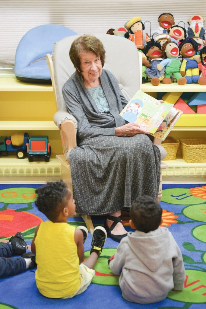 Janis Santos likes to say she “manages by walking around,” which includes regular sessions where she reads to children.