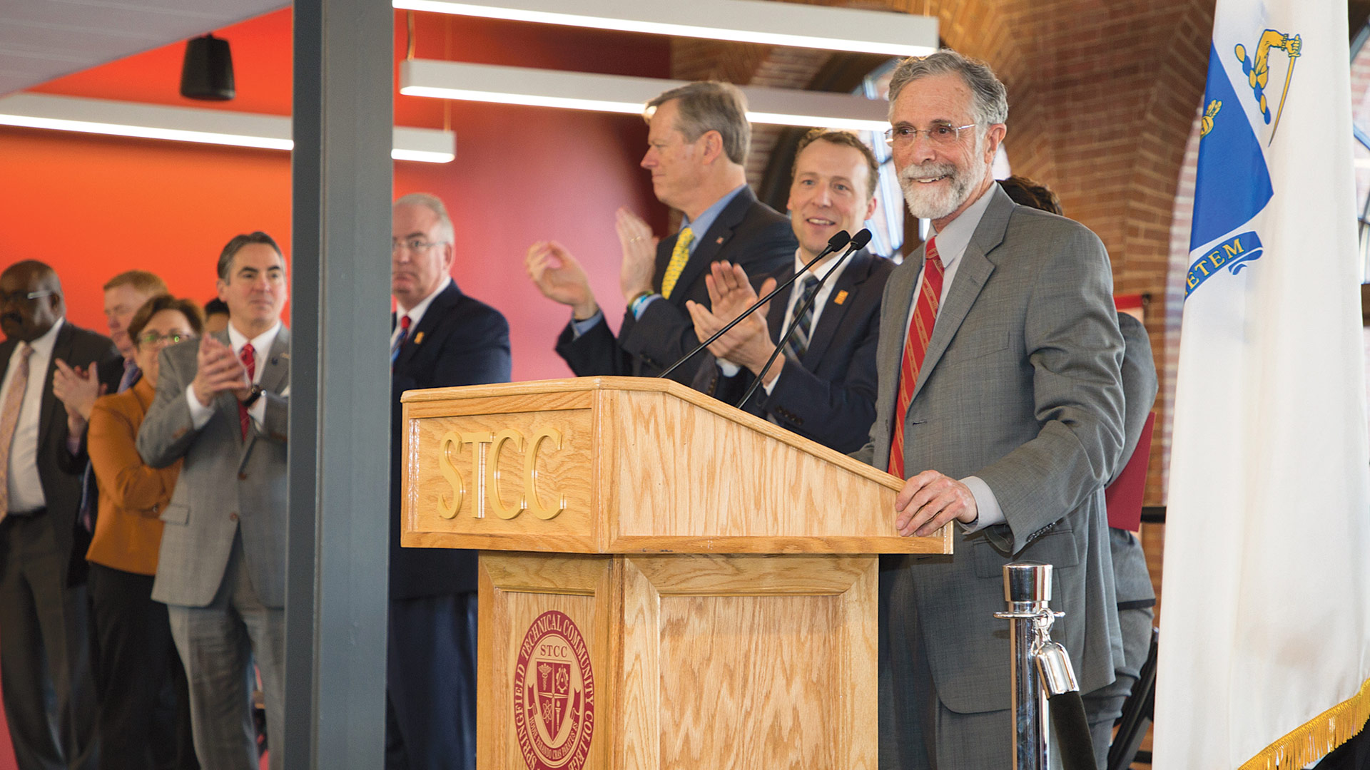 Rubenzahl addresses those gathered for the ceremonies, with Cook and Baker to his right