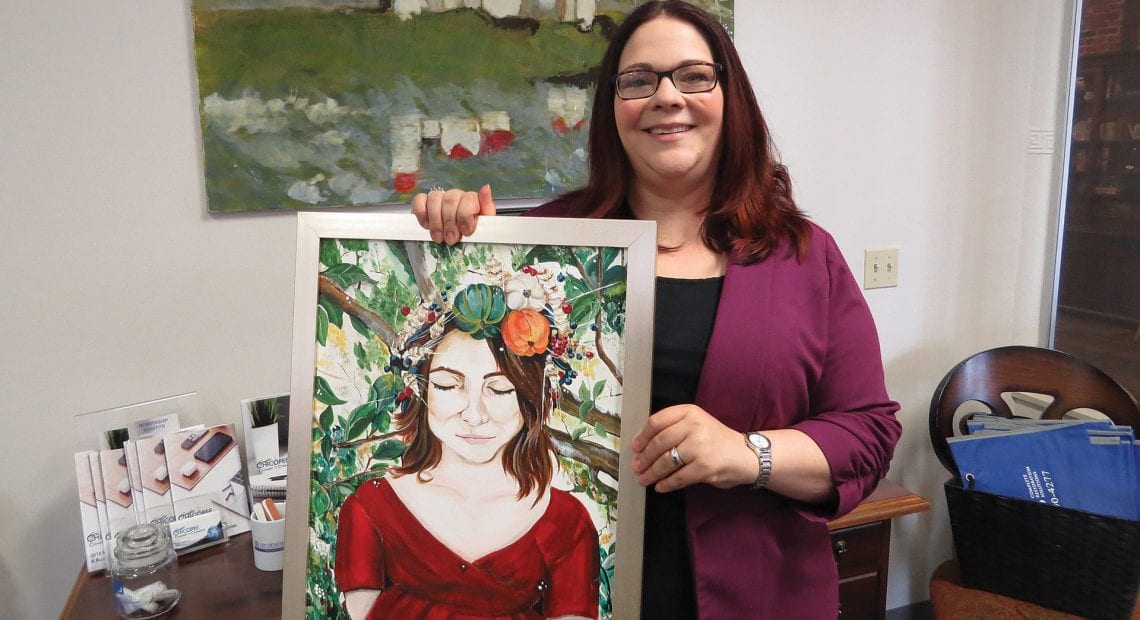 Jessica Roncariti-Howe, here displaying one of her own paintings