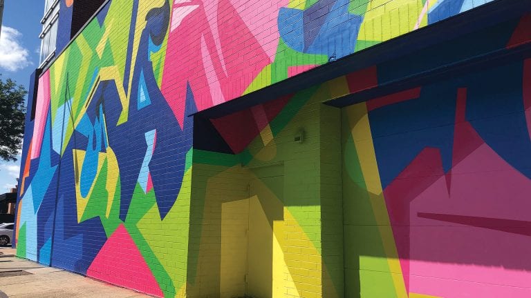 The East Columbus parking garage after being colorfully decorated by artist Wane One from the Bronx, N.Y.