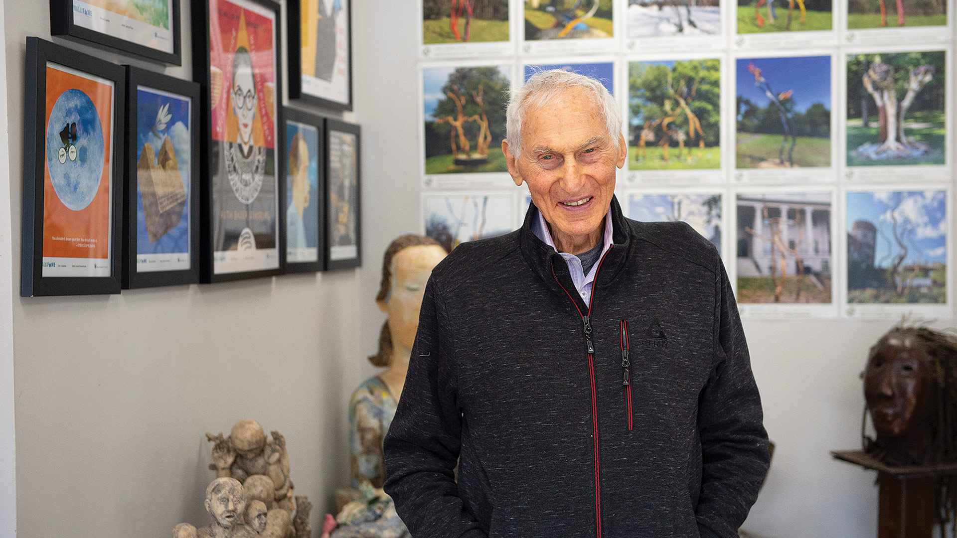 Behind Harold Grinspoon are photos