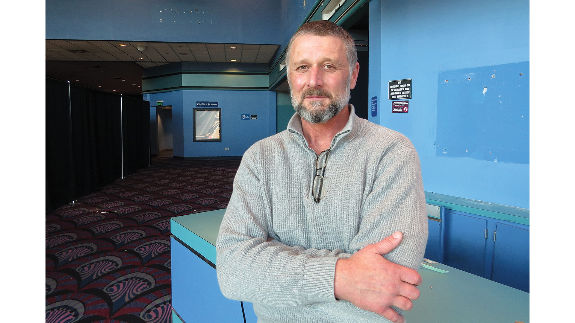 Dave Thompson stands in the lobby of the former Cinemark Theaters