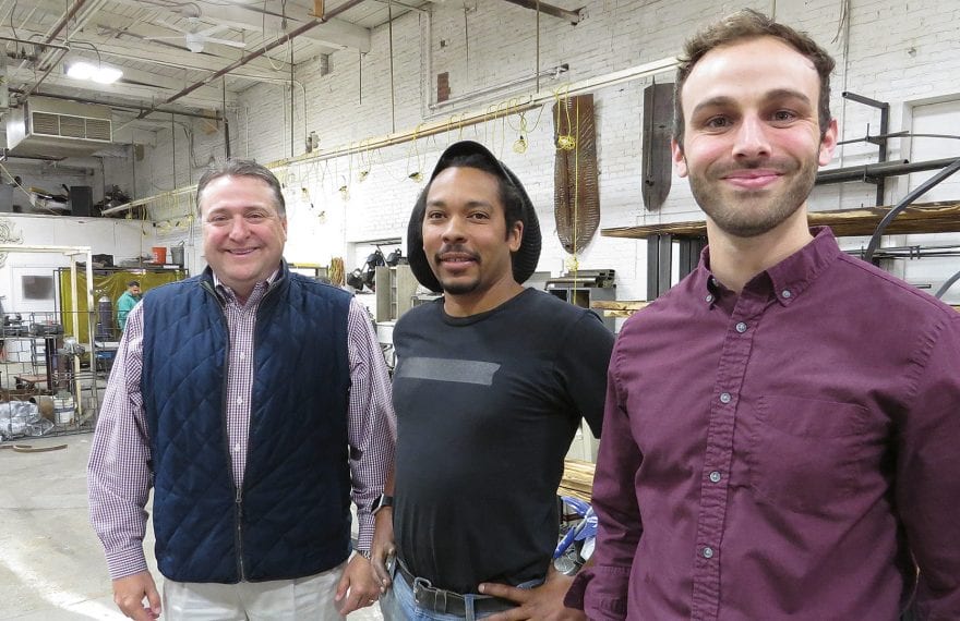 WestMass CEO Jeff Daley (left) and Sean O’Donnell (right), the agency’s Economic Development planner and leasing manager, with metal sculptor Kamil Peters, who relocated to Ludlow Mills last summer.