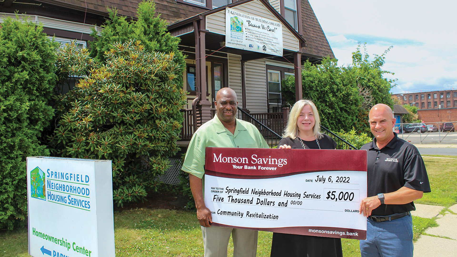 bank President and CEO Dan Moriarty (right) and Dina Merwin, the bank’s senior vice president, chief risk and senior compliance officer (center), visit Leo Williams, president and CEO of Springfield Neighborhood Housing Services, to present his organization with a $5,000 donation.