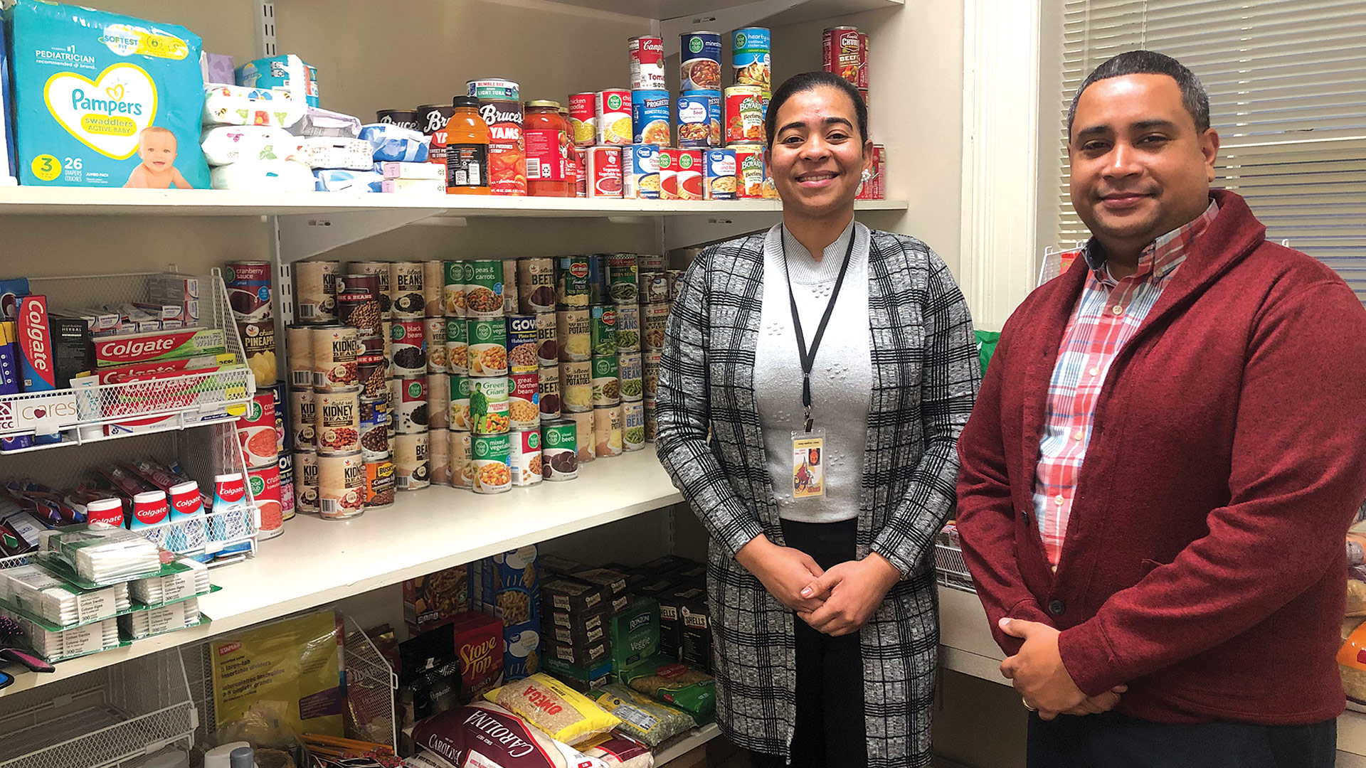 Pictured: two staff members at the Center for Access Services at STCC — Helen Angeles, assistant, and Luis Martinez, special programs coordinator — stand in the food pantry on campus known as the Ram Minimart.