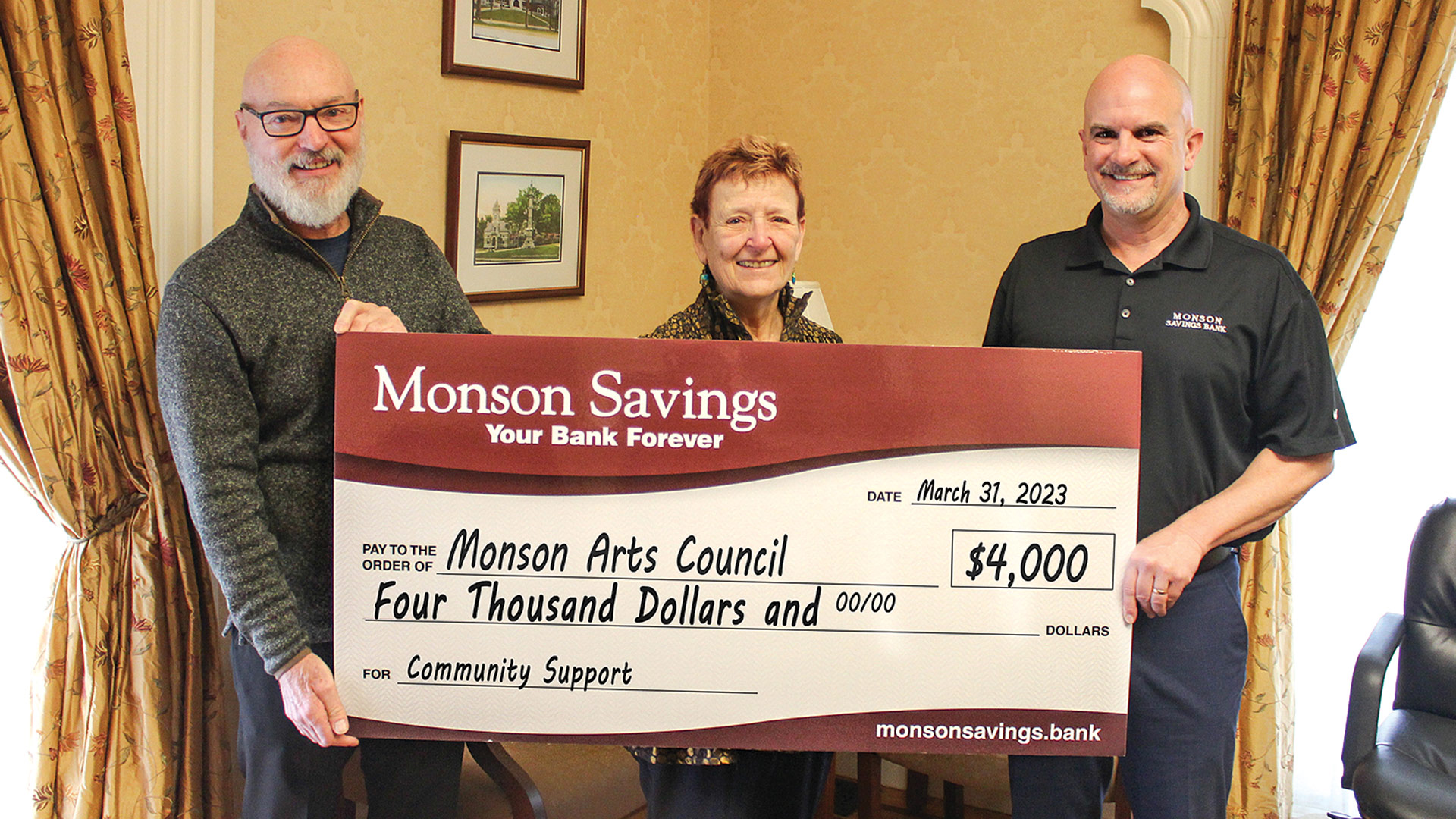 Pictured: Moriarty (right) presents the $4,000 donation to Susan James and David Dupuis of the Monson Arts Council.
