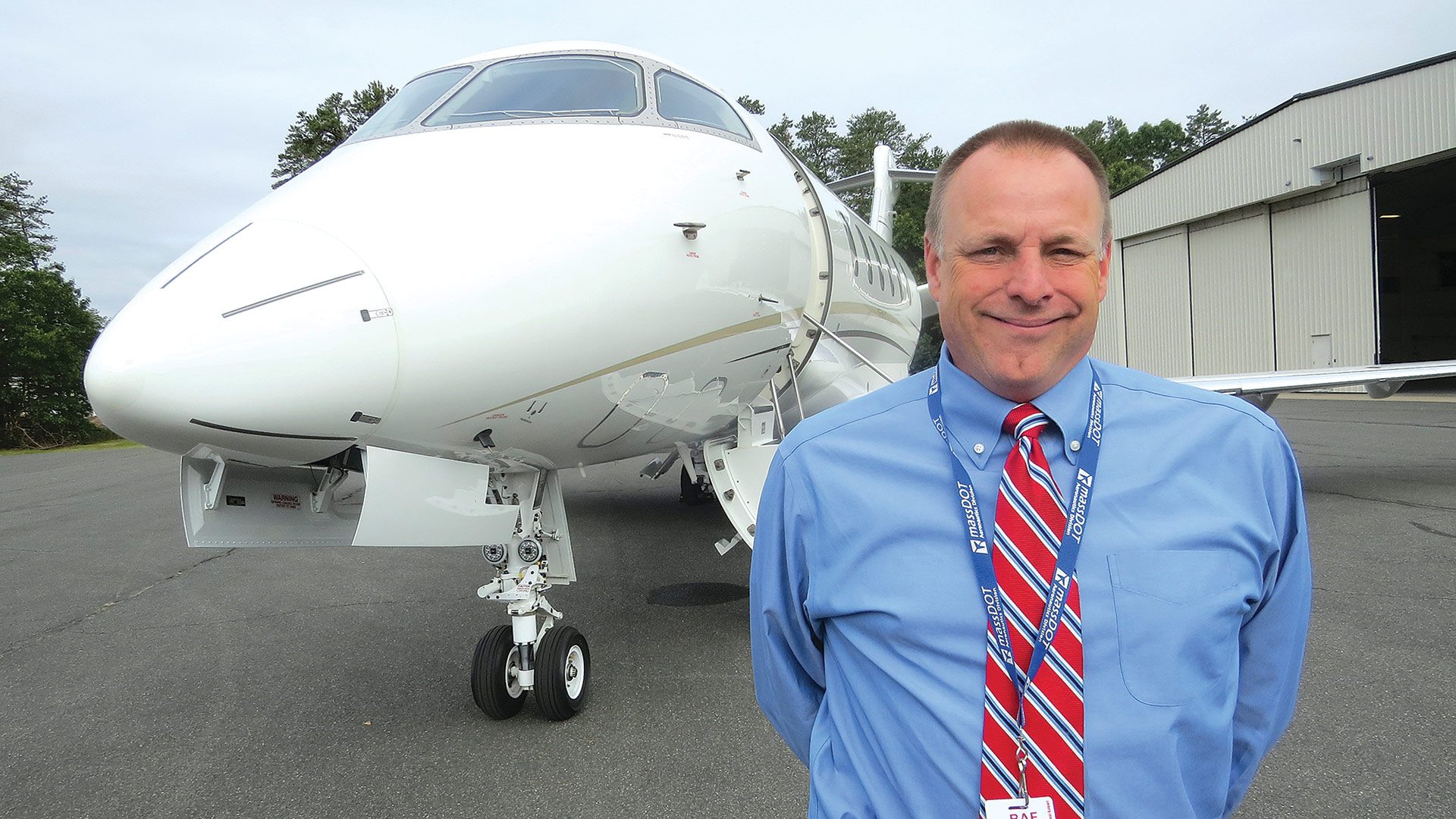Chris Willenborg stands in front of one of the private jets
