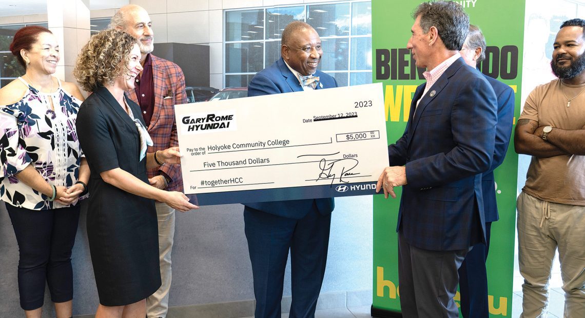 Gary Rome (right) presents the check to Timmons (center) and HCC Vice President of Institutional Advancement Amanda Sbriscia (left).