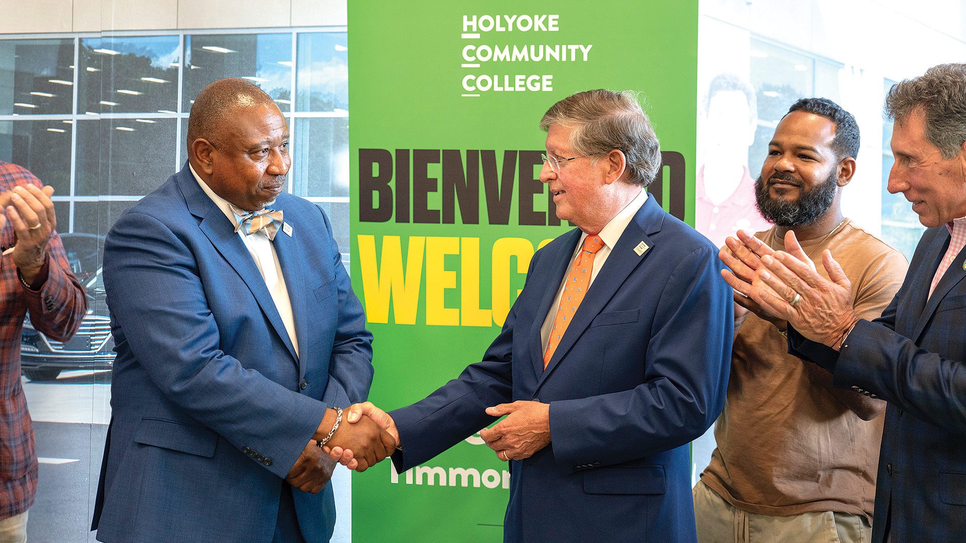 Timmons shakes hands with Robert Gilbert, chair of the HCC board of trustees.