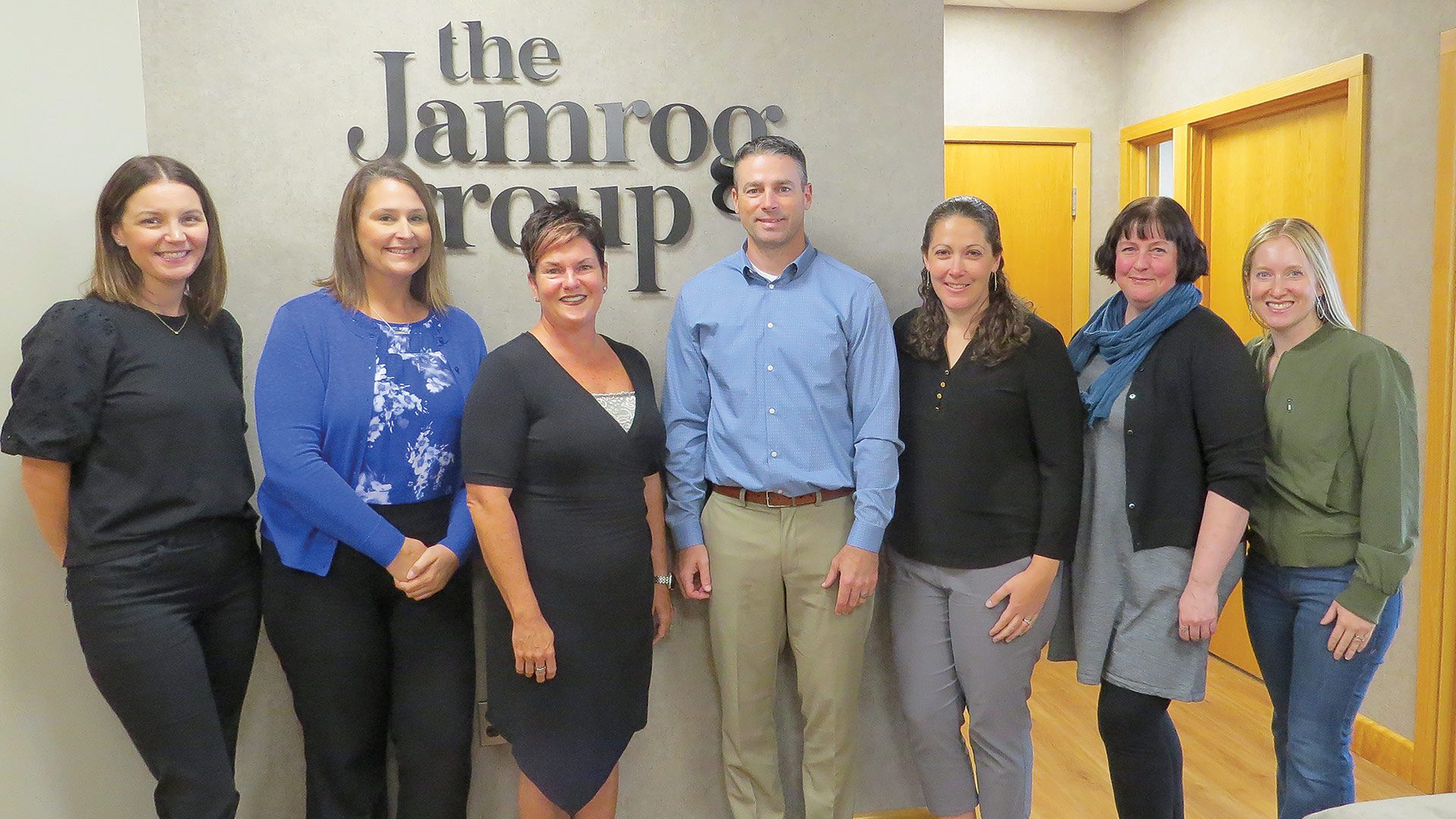 Amy Jamrog, seen here with her team at the Jamrog Group