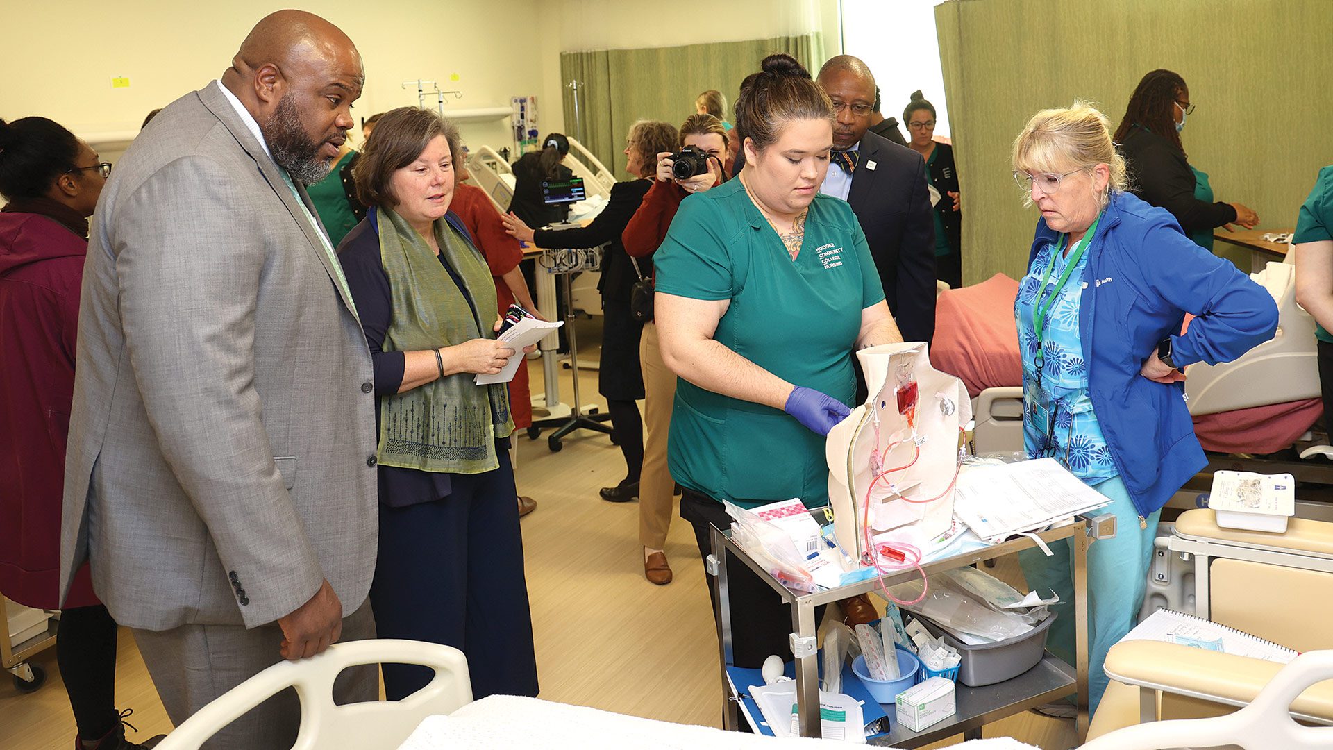 Pictured: HCC nursing student Katelynn Richard, center, practices under the supervision of Instructor Dorothy Shannon as Secretary of Education Patrick Tutwiler, state Sen. Jo Comerford, and HCC President George Timmons look on