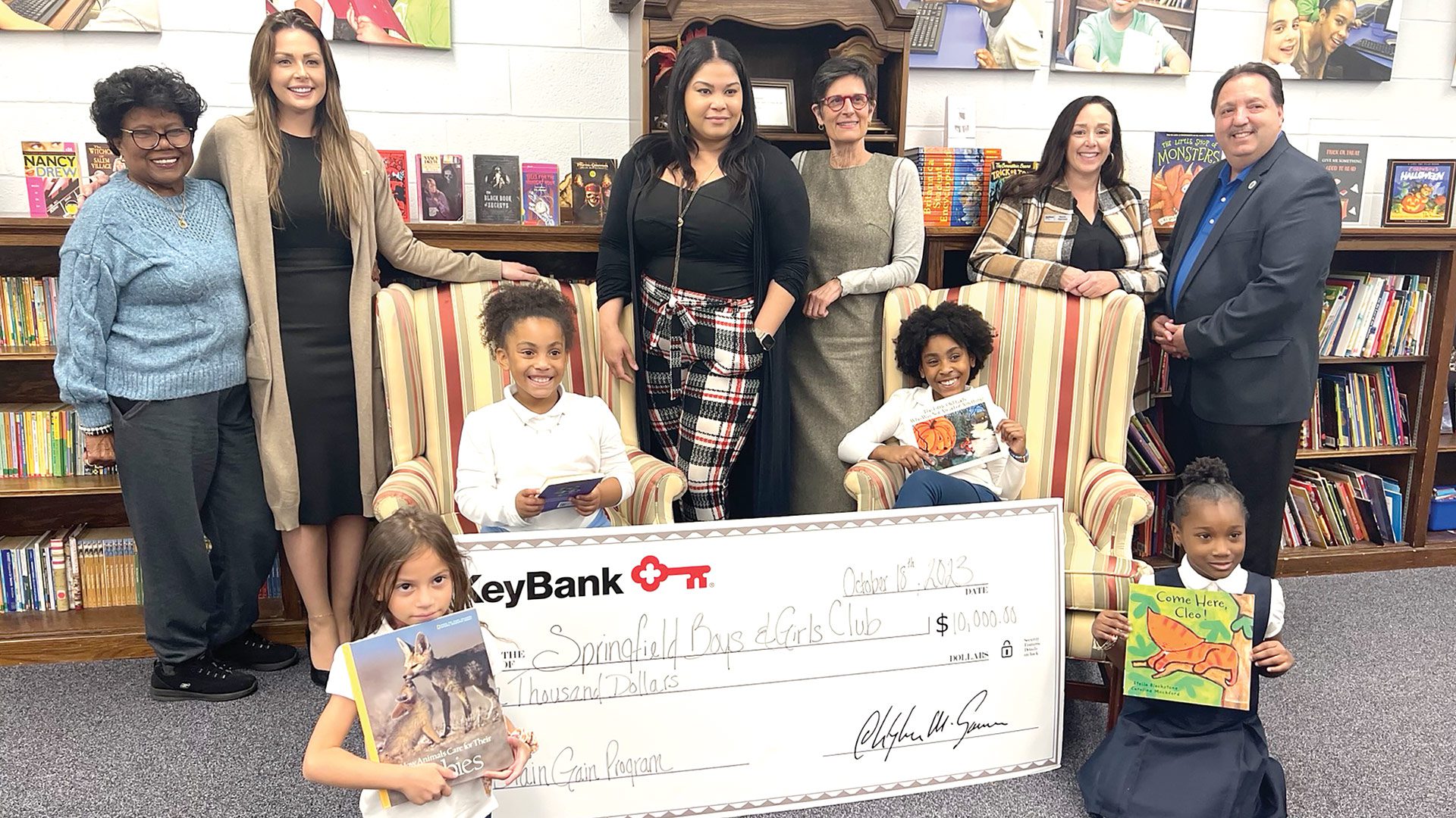 Pictured at top, from left: SBGC board member Aleana Laster; KeyBank Corporate Responsibility Officer Analisha Michanczyk, KeyBank Branch Manager Vanity Bryant, SBGC Director of Development Karen Natsios, KeyBank Area Retail Leader Sarah Germini, and SBGC Executive Director Vinnie Borello with students in the Brain Gain program