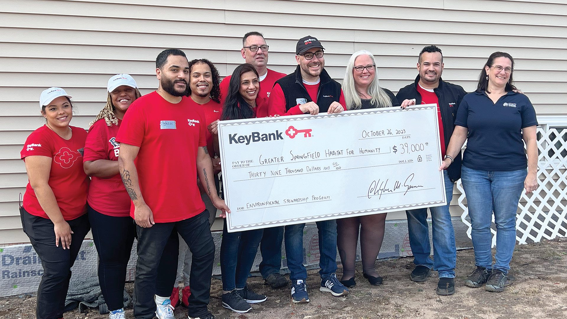 Pictured above, from left: KeyBank employees Janis Deynes, Sharia Coley, Josh Flores, Norbert Grant III, Priya Tater, Tom Morace, Jeff Guyott,  Kendle Taylor, and Tito Ramon with Habitat for Humanity Executive Director Aimee Giroux.