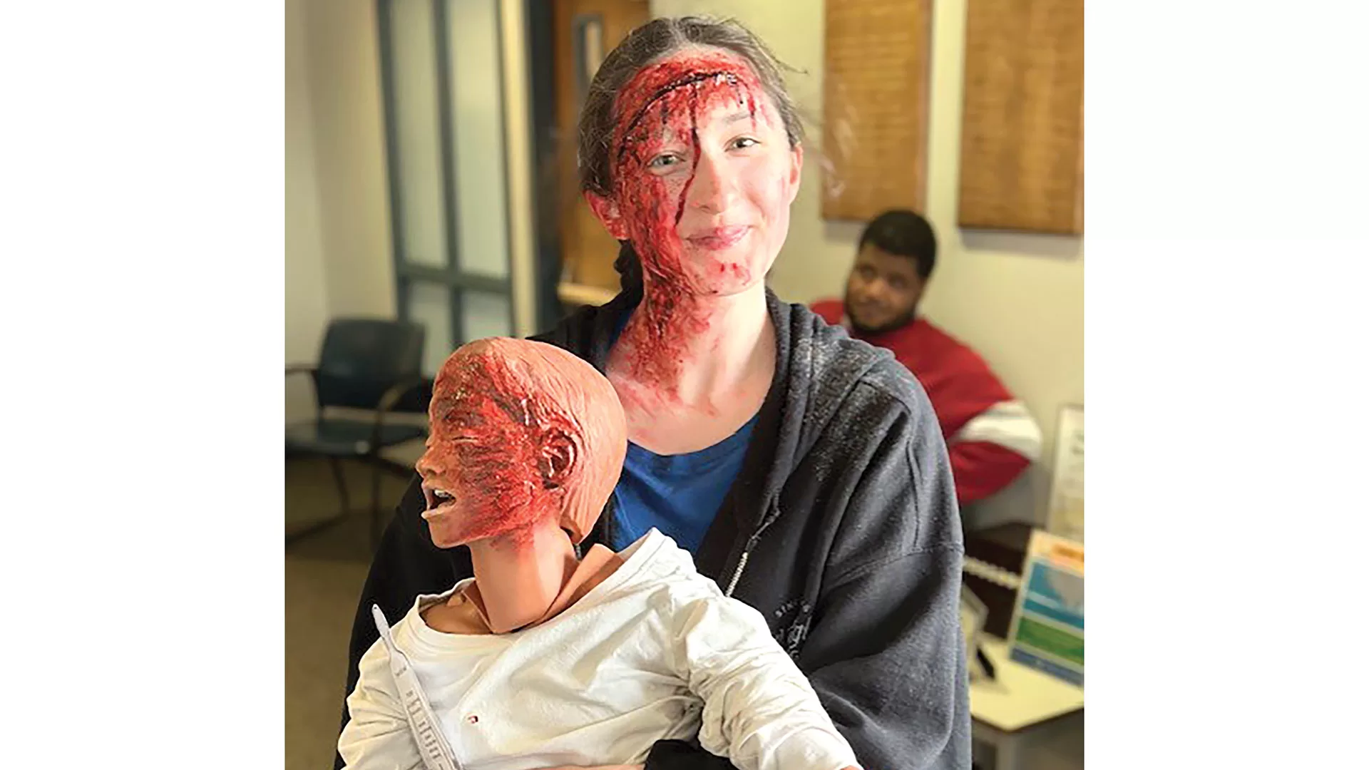 Southwick High School student Abigail Grazia uses her moulage skills on herself and a dummy to add some striking realism.