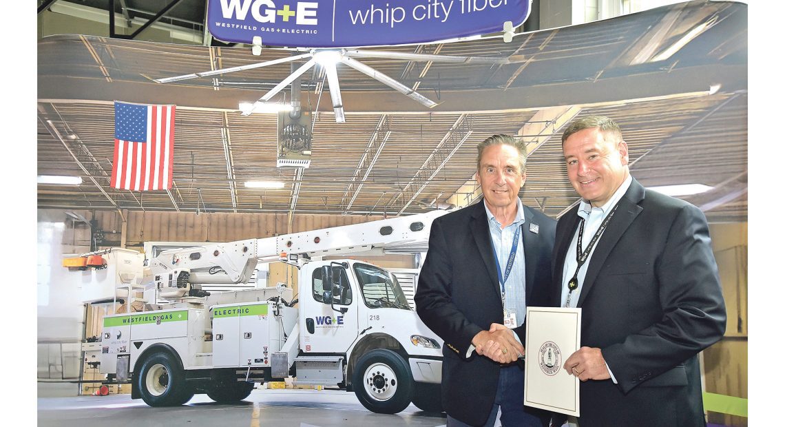 Mayor Mike McCabe, left, presents Westfield G&E General Manager Tom Flaherty