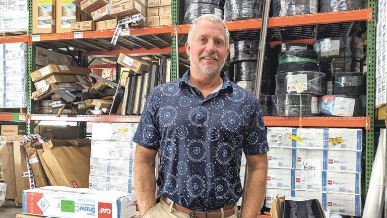Adam Quenneville stands in his warehouse
