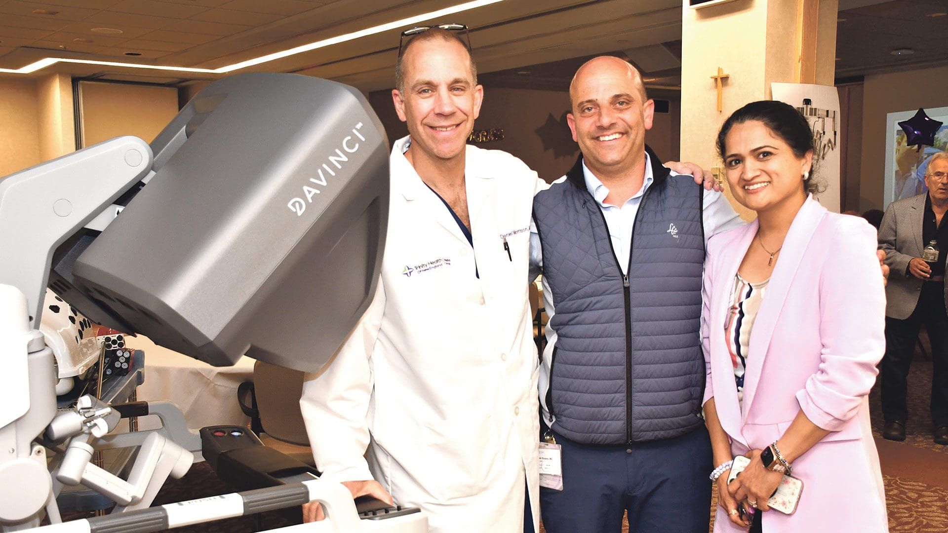Dr. Laki Rousou (center) celebrates his 1,000th da Vinci procedure with Mercy’s Chief of Surgery Dr. Dan Morrison (left), and Chief Medical Officer Dr. Asha Dhamija.