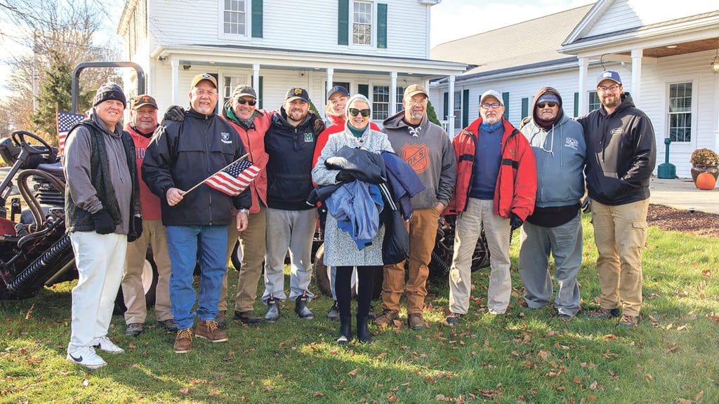 Kim Lee, center, with groundskeepers at the Country Club of Wilbraham, whom she successfully recruited to collect winter coats for children.
