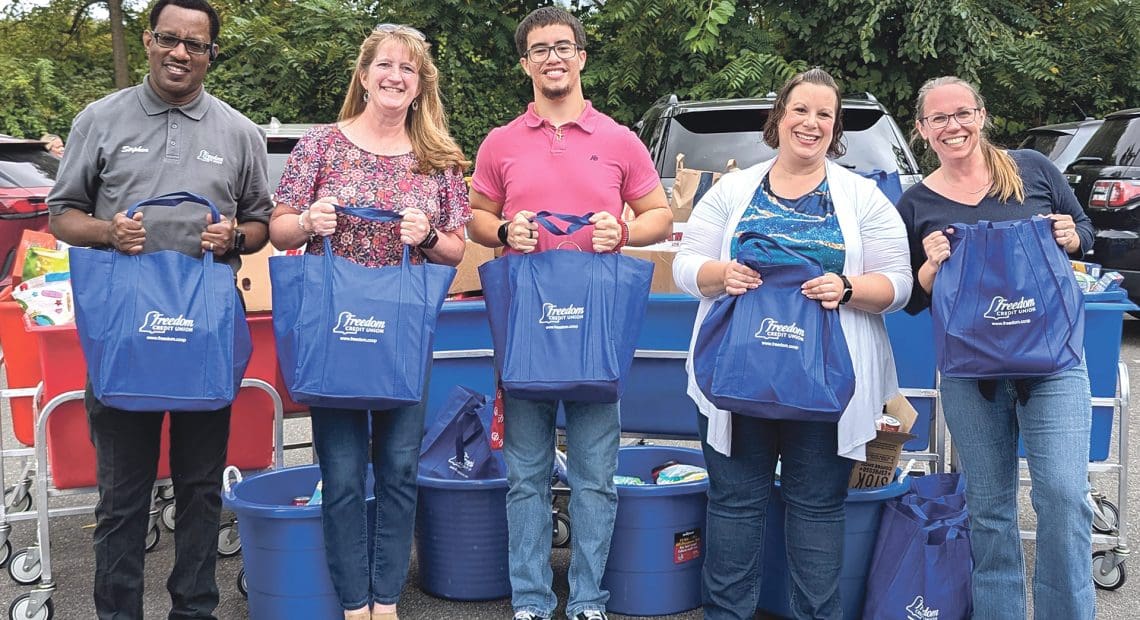 Pictured, from left: Stephen Phillips, Kara Herman, Nathaniel Claudio, and Natasha Cassidy from Freedom Credit Union, and Kristen McClintock, executive director of the Gray House. (Photo courtesy of Freedom Credit Union)
