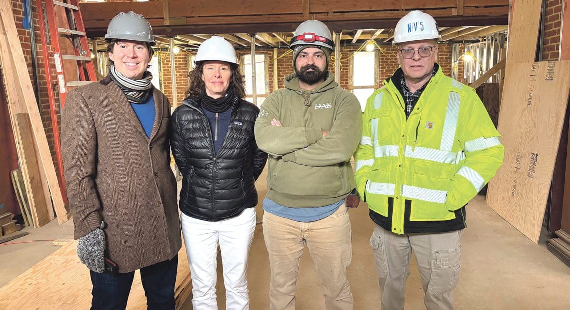 From left, Lee Pouliot, Krista Benoit, Brett Brown, and Bob Alger stand in the main entrance to the former main library in Chicopee, now undergoing historic rehabilitation for use as a community hub.
