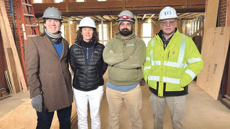 From left, Lee Pouliot, Krista Benoit, Brett Brown, and Bob Alger stand in the main entrance to the former main library in Chicopee, now undergoing historic rehabilitation for use as a community hub.