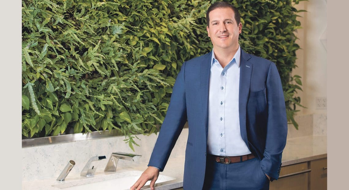 Bill Gagnon stands near one of the living walls