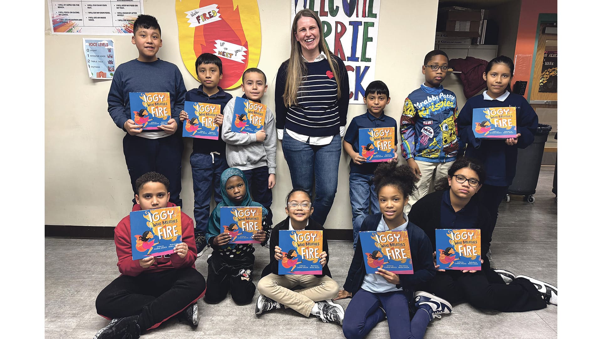 Pictured is author Carrie Kruck with fourth-grade students at Sumner. Link to Libraries donated a copy of Kruck’s debut picture book, Iggy Who Breathes Fire, to every fourth-grader at the school.