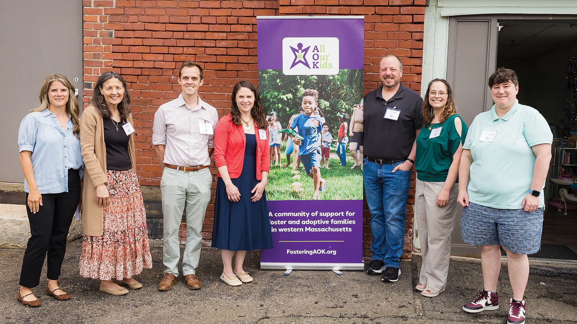 All Our Kids hosted an open house on May 7. Marianna Litovich (pictured second from right, with AOK board members) founded the nonprofit and has grown it over the past decade as an organization dedicated to building community, providing resources, and increasing public awareness of the foster care system while encouraging active community involvement. (Photo by Hillary Lynn Photography)