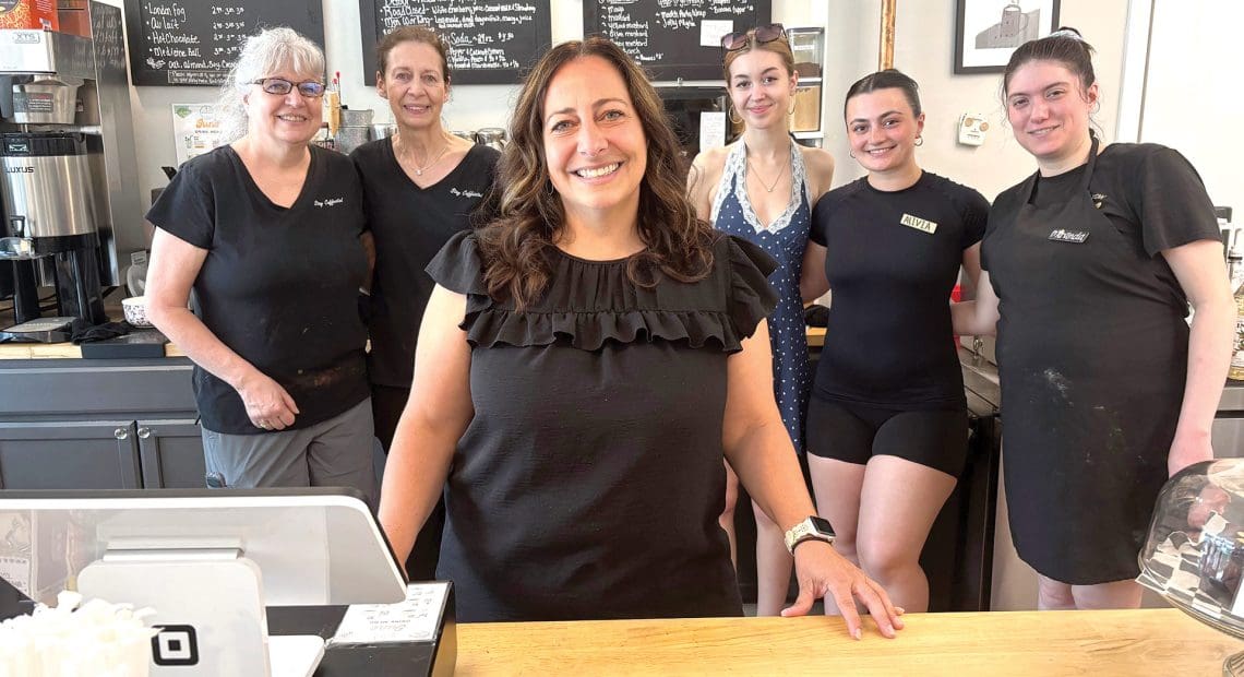 Amanda Roy, center, with several staff members at the Better Bean coffee shop on Main Street in Monson.