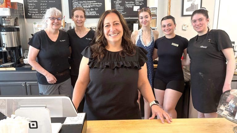 Amanda Roy, center, with several staff members at the Better Bean coffee shop on Main Street in Monson.