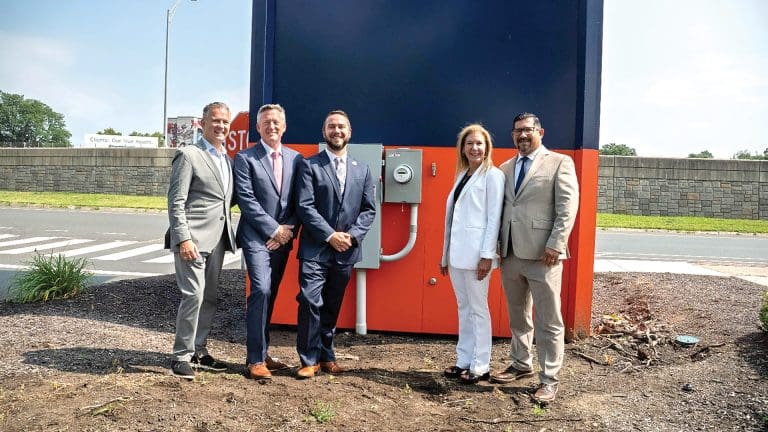 From left: state Rep. Brian Ashe, Itron Vice President Jim Fisher, Basketball Hall of Fame Vice President of Marketing Paul Dionne, Eversource Vice President of Customer Experience and Energy Strategy Penni Conner, and Eversource Director of Metering and Smart Meter Operations Luis Pizano stand in front of the newly installed smart meter at the Hall of Fame.