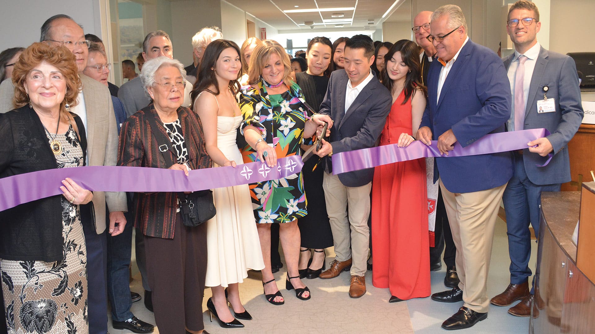 Yee family members and guests cut the ribbon on the Andy Yee Palliative Care Unit in May.
