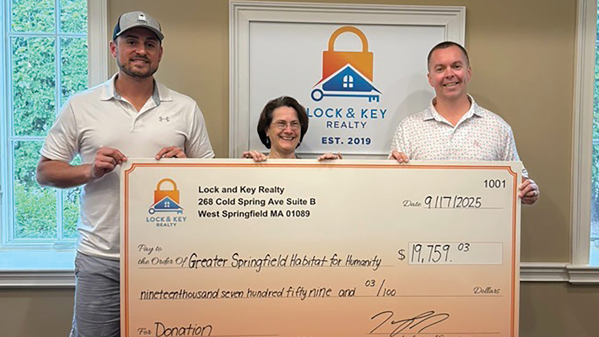 Pictured from left: Jordan Healy of Lock and Key Realty, Aimee Giroux of Habitat for Humanity, and Marc Murphy of Lock and Key Realty.