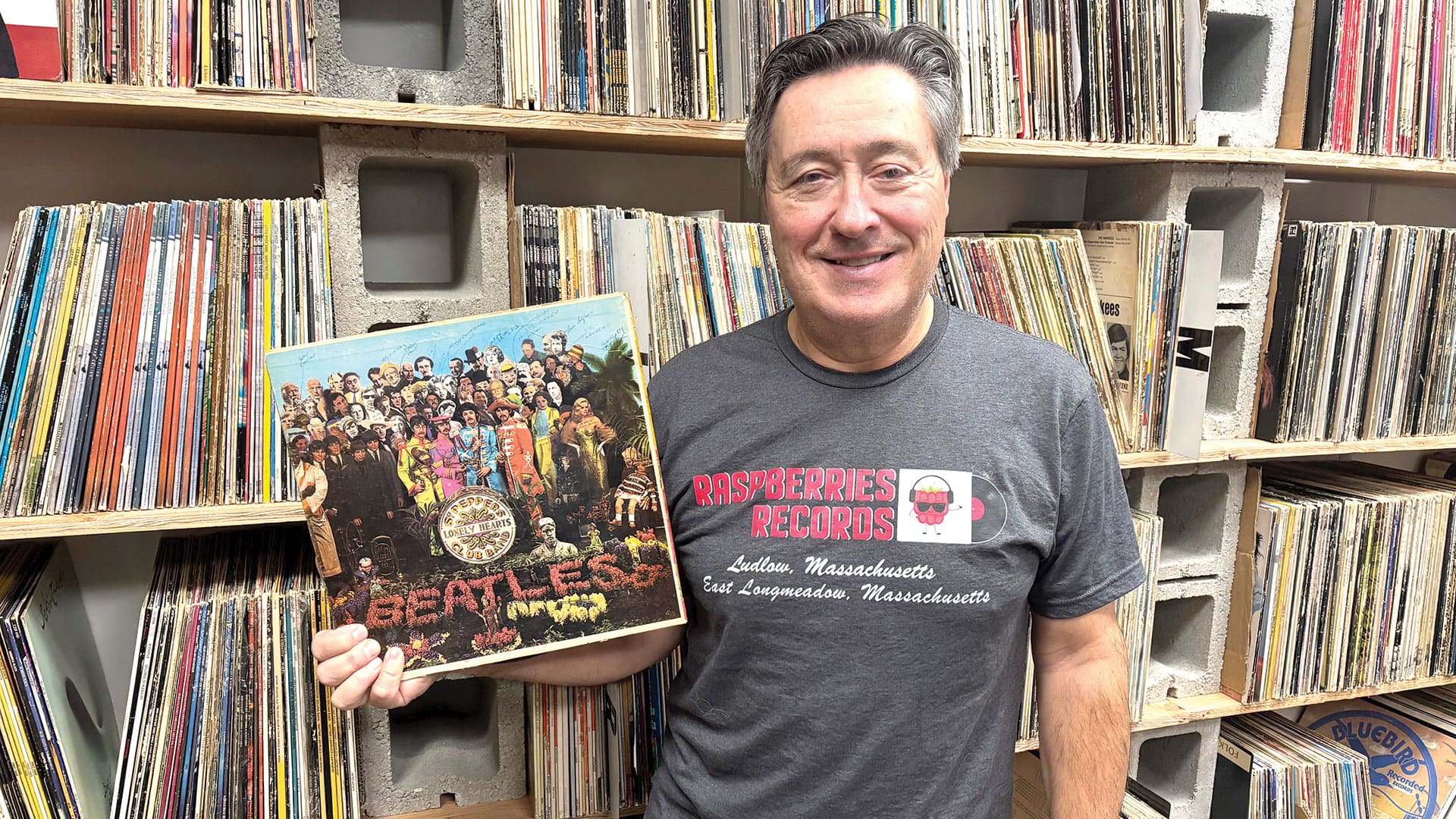 Bob Roccanti, seen here with a copy of the Beatles’ Sgt. Pepper’s Lonely Hearts Club Band, has amassed more than 71,000 records in his stores.