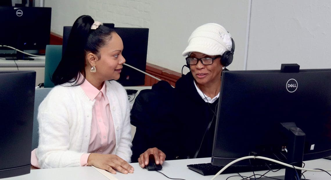Katherine Ortiz (left), an education and career advisor, seen here assisting a student in a workforce development class, will oversee college and career workshops as part of the Workforce Readiness Academy at STCC.