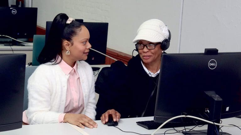Katherine Ortiz (left), an education and career advisor, seen here assisting a student in a workforce development class, will oversee college and career workshops as part of the Workforce Readiness Academy at STCC.