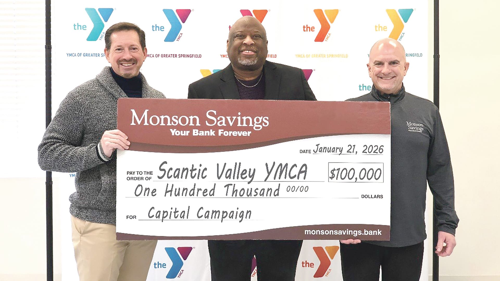Monson Savings Bank President and CEO Dan Moriarty (right) and Executive Vice President and COO Michael Rouette (left) recently presented the pledge to Dexter Johnson (center), president and CEO of the YMCA of Greater Springfield.