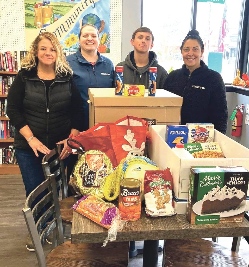 Julie Quink, left, and other Burkhart Pizzanelli team members take part in a program run by the Parish Cupboard, which provides meals and groceries to individuals and families in need.